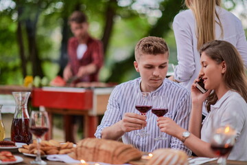 friends having picnic french dinner party outdoor during summer holiday