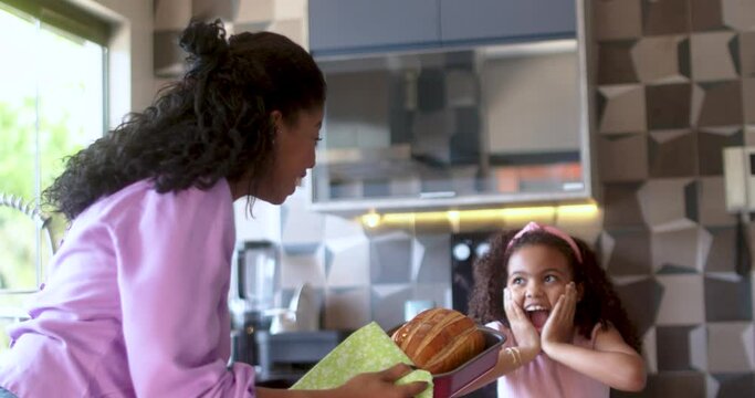 Happy latinx family in the kitchen.mother and daughter preparing bread