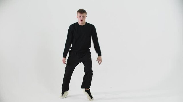 Dancing popping - young man freestyle dancing on cyclorama
