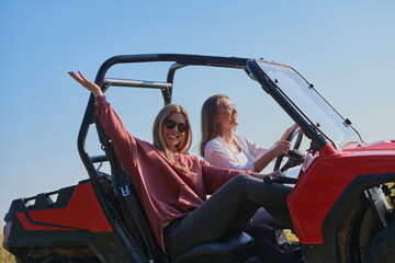 girls enjoying a beautiful sunny day while driving an off-road car