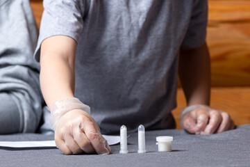 Chemistry education and study concept. Close up of the boy holds test tubes of chemical elements, for experiments at home