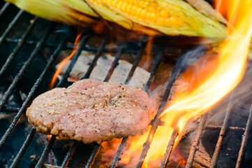 Flame grilling home made burgers on the barbecue