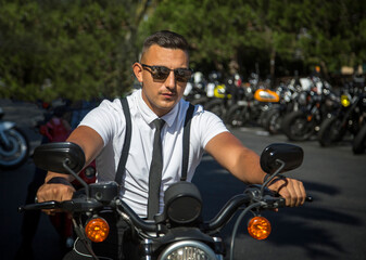 Fototapeta na wymiar A man in vintage clothing on a motorcycle