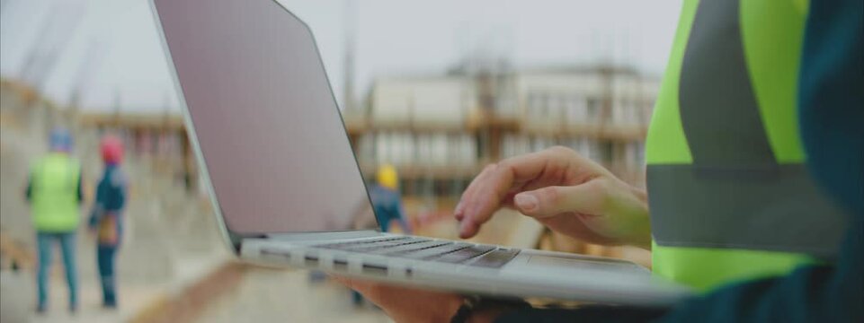 Close-up of using a modern Laptop Computer on the Construction Site.