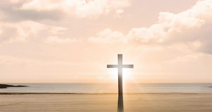 Animation of christian cross, sun shining over seaside on pink sky with clouds