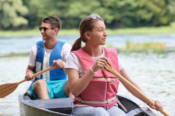 friends are canoeing in a wild river