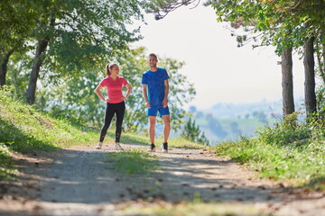 couple enjoying in a healthy lifestyle while jogging on a country road