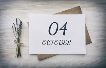 october 04. 04th day of the month, calendar date.White blank of paper with a brown envelope, dry bouquet of lavender flowers on a wooden background. Autumn month, day of the year concept