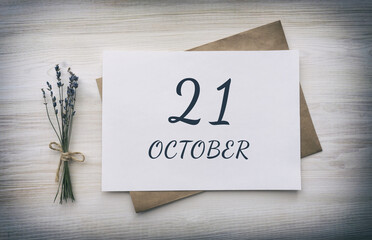 october 21. 21th day of the month, calendar date.White blank of paper with a brown envelope, dry bouquet of lavender flowers on a wooden background. Autumn month, day of the year concept