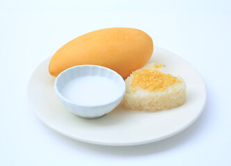 Sweet ripe golden mango and sticky with coconut cream on white circle ceramic plate isolated on white background