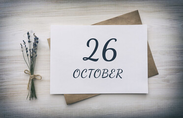 october 26. 26th day of the month, calendar date.White blank of paper with a brown envelope, dry bouquet of lavender flowers on a wooden background. Autumn month, day of the year concept