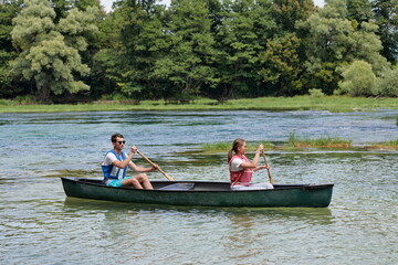 friends are canoeing in a wild river