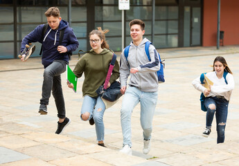 Group of running children with backpacks, they ready to go home from school