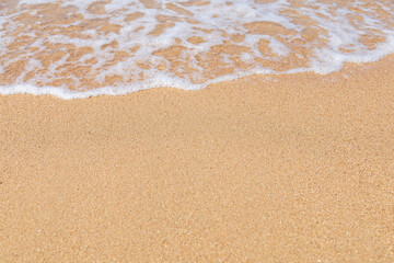Fototapeta na wymiar Soft wave of sea on sandy beach in summer. copy space.