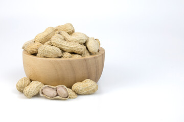 Peanuts in wooden bowl isolated on white background with clipping paths.