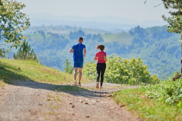 Obraz premium couple enjoying in a healthy lifestyle while jogging on a country road