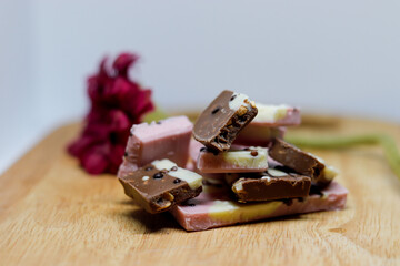 brown and rose chocolate with the flower in background