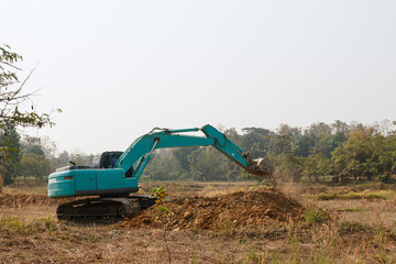  Excavators are digging the soil in the construction site with bucket lift up,location field outdoor