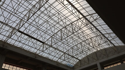 Metal building roof structures. The steel tubular structure of the transparent roof top of the building is hard to get into the bottom view. Selective focus