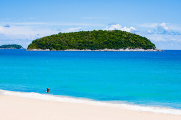 Fototapeta premium White Sand of Yanui Beach with Koh Man Island Background and Turquoise Andaman Sea in Summer, Phuket, Thailand