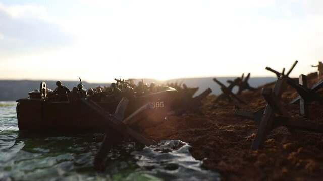World War 2 reenactment (D-day). Creative decoration with toy soldiers, landing crafts and hedgehogs. Battle scene of Normandy landing on June 6, 1944. Selective focus