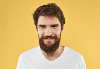 Obraz premium portrait of a man white t-shirt yellow background cropped view Copy Space