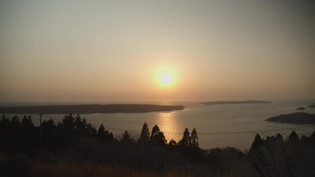 A gloomy orange sunset over the ocean in japan ishinomaki close to where the tsunami hit