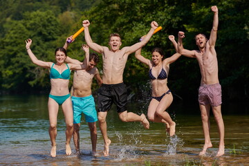 Obraz premium group of happy friends having fun on river