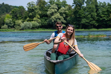 friends are canoeing in a wild river