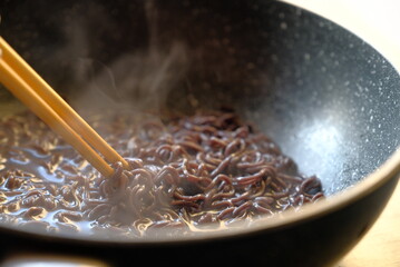 bowl ramen soup. Instant noodles Tom Yum Koong with egg and celery on wood table,hot bowl
