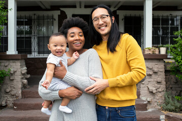Beautiful multiethnic family standing at the porch during covid19 lockdown - Powered by Adobe