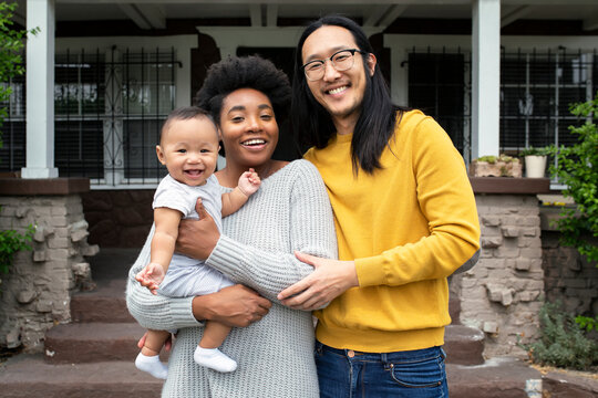 Beautiful multiethnic family standing at the porch during covid19 lockdown