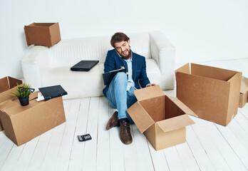 Business man near boxes with things unpacking moving to a new location office official lifestyle