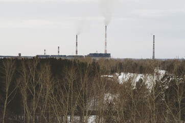 chimneys with smoke from a thermal station. urban boiler house polluting nature