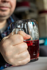 drinking red cider in a glass goblet, vertical.