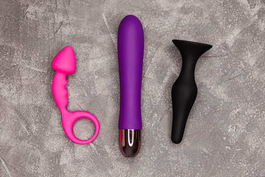 Design minimal dildo vibrator for clitoris. BDSM. Top view of vibrators. Sex toy for adult, dildo, vibrator on grey background. Place for text. Copy space. Flat lay. Sex shop concept. Safe love