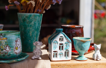 ceramic house, a bouquet of flowers in a vase, handmade fair, porcelain teapot
