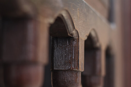 The art of carving wood fence details with macro and blur look and dark brown wood color use for traditional building fence