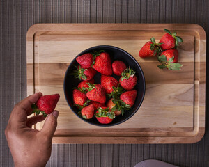 Fresas en un plato sobre una tabla listas para preparar un rico postre
