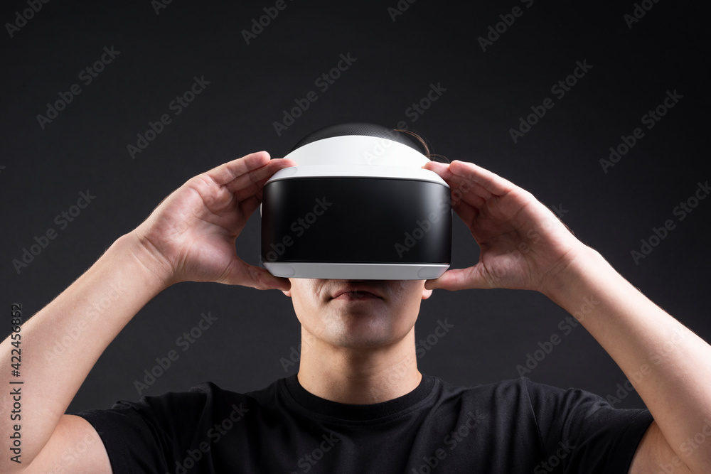 Poster man using virtual reality gadget for entertainment