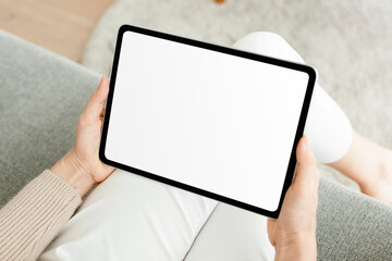 Hand holding digital tablet with blank white screen