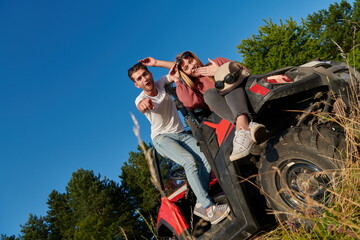 couple enjoying beautiful sunny day while driving a off road buggy