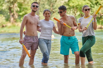 group of happy friends having fun on river