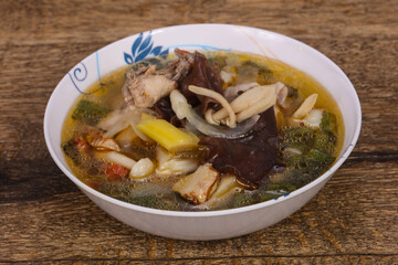 Thai style soup with meat and mushrooms