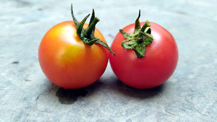 fresh red tomato isolated on stone background
