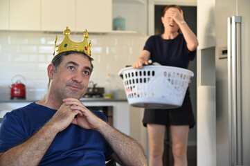 Lazy mature adult man behaving like a king watching TV