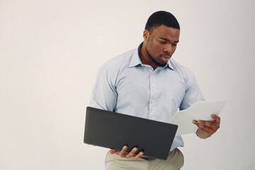 Handsome black man standing on a white background