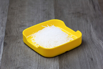 fresh raw vermicelli sliced on square plate  on wood, wooden background,set shabu, hot pot ingredients.