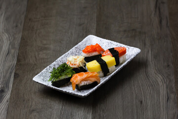 Sushi Set sashimi and sushi rolls served on wood background