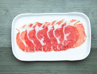 fresh raw pork, meat ,beef, belly, sliced on square plate  on wood, wooden background,set shabu, hot pot ingredients.
